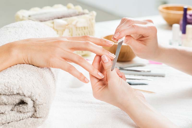 Girl getting her nails filed